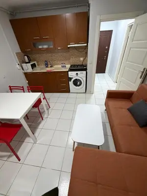 a kitchen and a living room with a couch and a table at Istanbul Family Apartment in Istanbul
