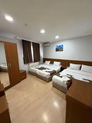 a large room with two beds and a couch at Istanbul Family Apartment in Istanbul