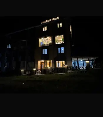 a tall building at night with its lights on at Lina Apart in Arnavutköy