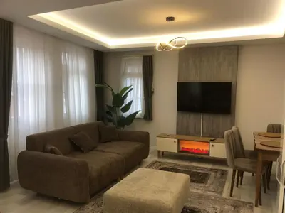 a living room with a couch and a flat screen tv at ZARA'S HOME in Istanbul in Istanbul