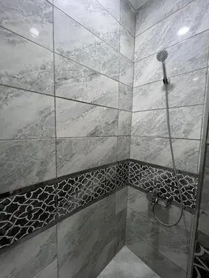 a bathroom with a shower with a tiled shower at KAMER Apart Hotel in Istanbul