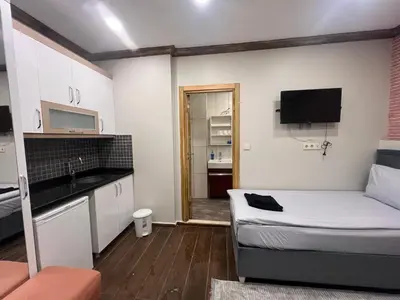 a small room with a bed and a kitchen at KAMER Apart Hotel in Istanbul