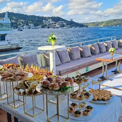 a table with plates of food on a boat at Albaker Tour VIP Yacht in Istanbul