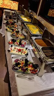 a buffet line with many plates of food at Albaker Tour VIP Yacht in Istanbul