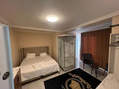 a bedroom with a bed and a glass shower at The walens hotel in Istanbul