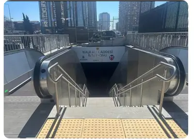 a group of metal stairs with a boat in the background at Take Me Home in Istanbul