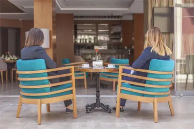 two women sitting at a table in a restaurant at Lamec Hotel Business in Gebze