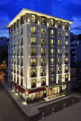 a large white building with many windows at night at Icon Hotel Taksim in Istanbul