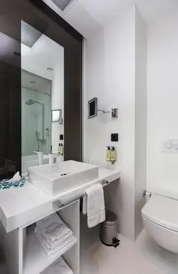 a white bathroom with a sink and a toilet at Bankerhan Hotel Galata - Adults Only Special Category in Istanbul