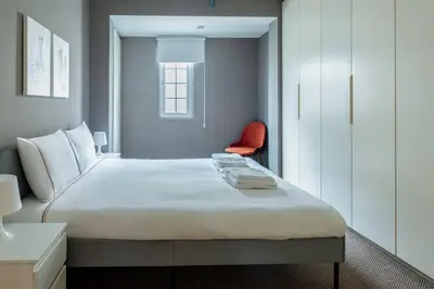 a bedroom with a large bed and a red chair at Luxury Modern 3Bed25Bath Central Bright Pad #375 in Istanbul