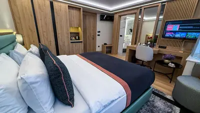 a bedroom with a bed and a desk and a television at Vital Hotel Suites in Istanbul