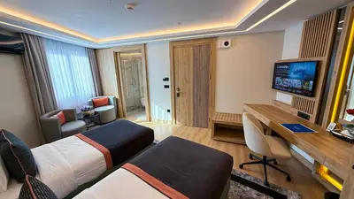 a hotel room with two beds and a desk at Vital Hotel Suites in Istanbul