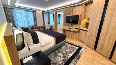 a hotel room with a bed and a television at Vital Hotel Suites in Istanbul