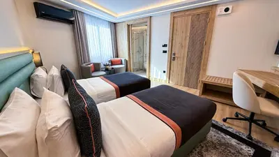 a hotel room with two beds and a desk at Vital Hotel Suites in Istanbul