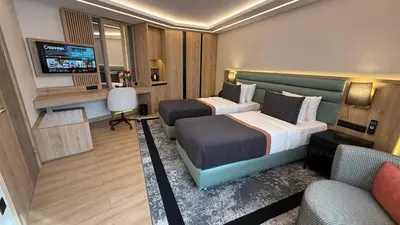 a hotel room with two beds and a television at Vital Hotel Suites in Istanbul