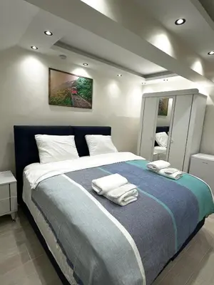 a bedroom with a large bed with towels on it at Öz Suit in Istanbul
