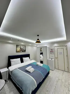 a bedroom with a large bed with two towels on it at Öz Suit in Istanbul