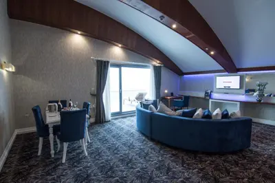 a hotel room with a large couch and a table at Elite Hotels Darica Spa & Convention Center in Gebze