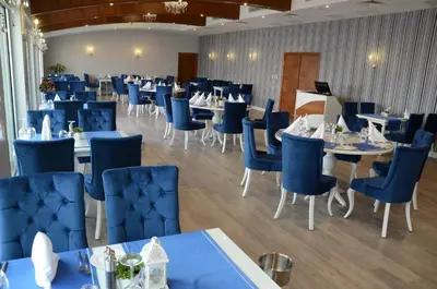 a dining room with blue chairs and tables at Elite Hotels Darica Spa & Convention Center in Gebze