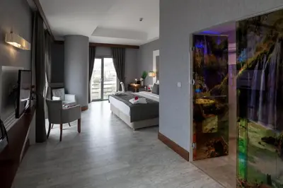 a living room with a bed and a couch in a room at Elite Hotels Darica Spa & Convention Center in Gebze