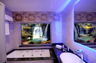 a bathroom with a large tub and a sink at Elite Hotels Darica Spa & Convention Center in Gebze