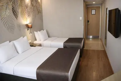 a hotel room with two beds and a flat screen tv at Riva Hotel Taksim in Istanbul