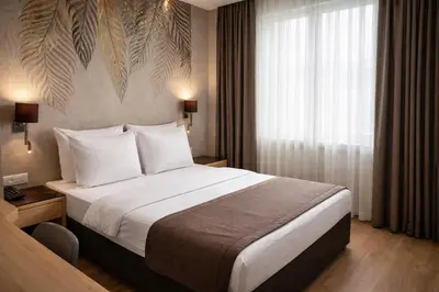 a hotel room with a large bed and a window at Riva Hotel Taksim in Istanbul