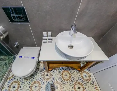 a bathroom with a sink and a toilet at Nenessa Airport Hotel in Arnavutköy