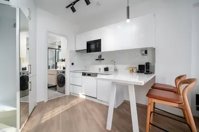 a white kitchen with a desk and a sink at Urban Quarters - Firuzağa in Istanbul