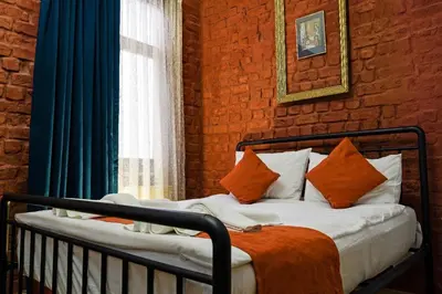 a bedroom with a bed with orange and white pillows at White Bolshoi Rooms in Istanbul