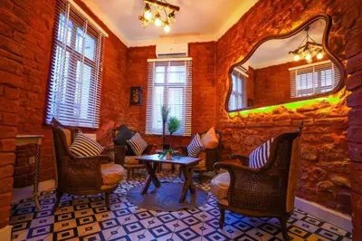 a room with chairs and a table and a mirror at White Bolshoi Rooms in Istanbul