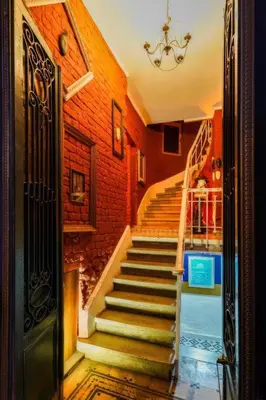 a staircase in a house with a brick wall at White Bolshoi Rooms in Istanbul