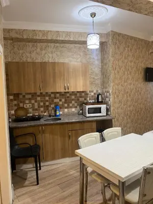 a kitchen with a table and a microwave at Nuray Hotel in Istanbul