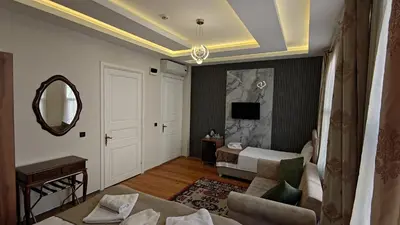 a living room with a couch and a mirror at Nuray Hotel in Istanbul