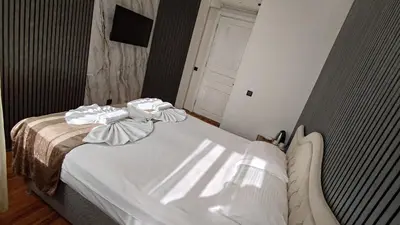 a bedroom with a bed with towels on it at Nuray Hotel in Istanbul