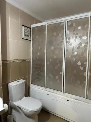 a bathroom with a white toilet and a shower at Brave otel in Darıca