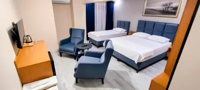a hotel room with two beds and a desk and chairs at Lantis Otel in Avcılar