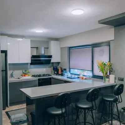 a kitchen with a counter with stools in it at Çınar home in Sapanca