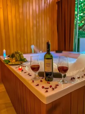 a bottle of wine and two glasses on a table at Meca Deluxe Otel Sapanca in Sapanca
