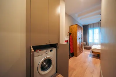a bathroom with a washing machine in a room at Galata Guest Teori in Istanbul
