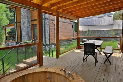 a wooden deck with a table and chairs on it at Lal Hayal Konakları in Sapanca