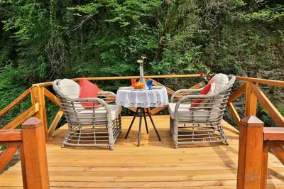 a wooden deck with a table and two chairs at Lal Hayal Konakları in Sapanca