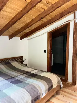 a bedroom with a bed and a wooden ceiling at Lal Hayal Konakları in Sapanca