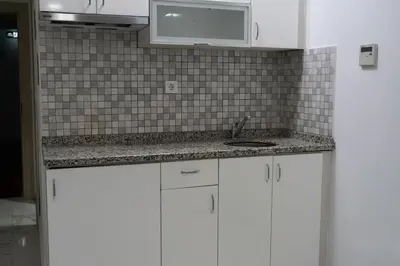 a kitchen with white cabinets and a sink at Eclipse Hotel in Istanbul
