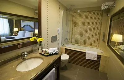 a bathroom with a sink and a toilet and a tub at GLK PREMIER Regency Suites & Spa in Istanbul