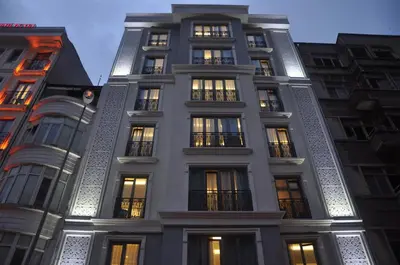 a tall building with lit windows at night at Inntel Hotel Istanbul in Istanbul