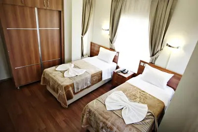 a hotel room with two beds and a window at Taksim Palace Hotel in Istanbul