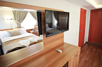 a hotel room with a bed and a flat screen tv at Taksim Palace Hotel in Istanbul