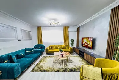 a living room with blue couches and a tv at Sisli Holiday 231 in Istanbul