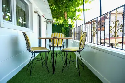 a table and four chairs on a balcony at Taksim Neo Pera Suites in Istanbul